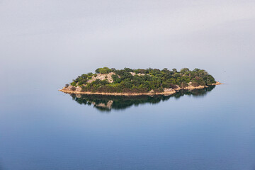 Poster - Aerial view of the island monastery on Lake Skadar, Montenegro, surrounded by pristine blue waters.