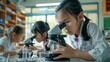 © Sasa Visual - A young girl student looks through a microscope in a classroom