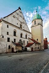 Poster - Brick tower of a historical church in the city of Wschowa in the evening