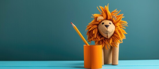 Poster - lion figurine handmade pencil holder, toilet paper roll craft, recycle concept, DIY for kids, simple activity. Copy space image. Place for adding text or design