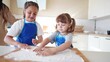 © maxximmm - children making dough in the kitchen. two little girls cook in the kitchen knead dough and flour indoors. happy family kid dream concept. children play cooking dough together at home fun