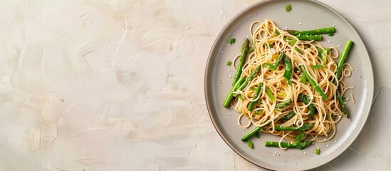 Leinwandbilder - soy asparagus noodles on a light gray plate, isolated on a pastel background. healthy food . Asian food. soy asparagus noodles top side view. with copy space image. Place for adding text or design