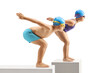 © Ljupco Smokovski - Full length profile shot of a little boy and girl swimmers ready to jump in a pool