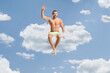 © Ljupco Smokovski - Man in swimwear sitting on a cloud up in the sky
