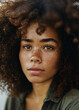© Tech - Mixed-race woman with curly afro hair and freckles