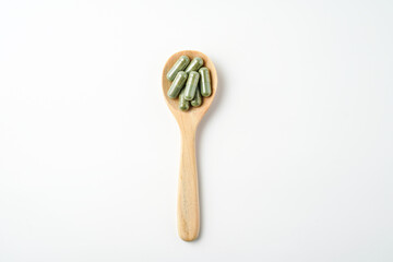 Wall Mural - Herbal capsules in wooden spoon, Natural herbs, Alternative Medicine, Herbal supplement