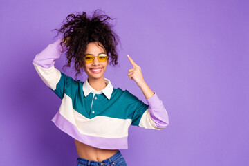 portrait of lovely young girl point finger hair wear shirt isolated on purple color background