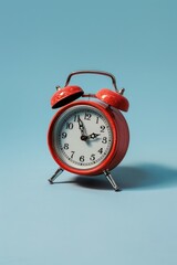 Aufkleber - A red alarm clock sitting on a blue surface