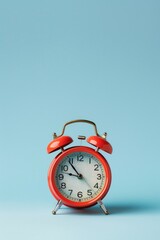 Aufkleber - A red alarm clock sits atop a blue surface, ready to wake someone up