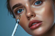 © Anastasia - Beautiful young woman with blue eyes receiving cosmetic injection