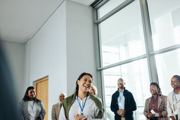 Wall Mural - smiling businesswoman speaker interacting with team during a conference