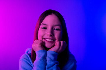 Poster - Photo of cheerful dreamy little lady dressed hoodie arms cheeks empty space isolated neon purple color background