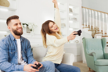 Poster - A man and woman are actively playing a video game together, immersed in the virtual world on the screen in front of them.
