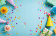 © Sagar - Colorful party decorations on light blue background, birthday gifts and paper hats