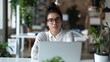 © Nicky - Young professional woman in a creative office, sitting at her desk with an empty laptop screen, illustrating digital marketing planning and communication in a dynamic work environment