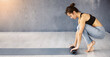 © Prostock-studio - A young woman in athletic wear rolls up her yoga mat after a workout session in a spacious, well-lit studio with hardwood floors. The soft morning sunlight streams into the room, copy space