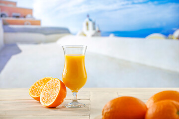 Wall Mural - Orange juice and fruits on table top and summer background.