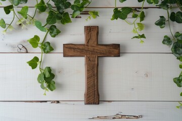 Wood cross on white bible with green vine border.