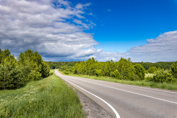 Wall Mural - A road with a blue sky in the background