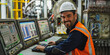 © Mr. Stocker - Smiling industrial worker operating computer in factory setting