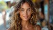 © Pavel Lysenko - A young woman with long, wavy blonde hair smiles warmly for the camera, her tanned skin glowing in the golden hour light