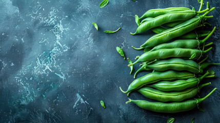 scattered fresh green beans on a dark textured surface, with copy space for text