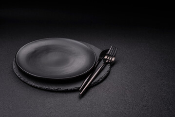 Empty round slate plate for template on the black background