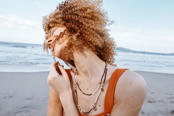 Wall Mural - Beach Wanderlust: Happy Smiling Woman with Backpack Embracing Freedom and Nature