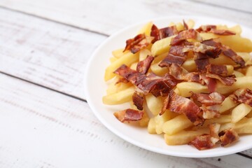 Wall Mural - Delicious French fries with bacon on wooden rustic table, closeup. Space for text