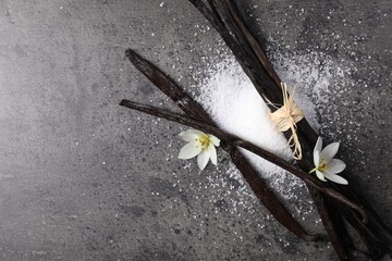 Sticker - Vanilla pods, sugar and flowers on gray table, flat lay. Space for text