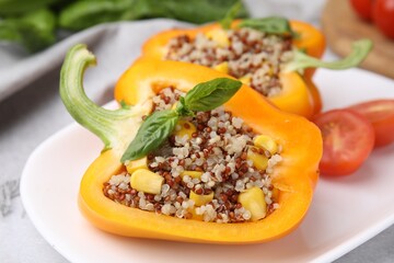 Poster - Quinoa stuffed bell pepper with basil on light table, closeup