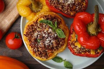 Wall Mural - Quinoa stuffed peppers with corn and basil on wooden table, flat lay