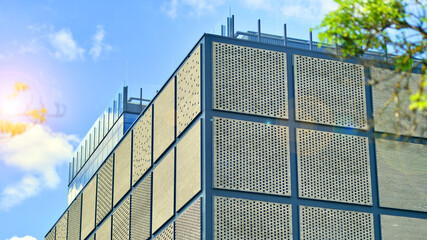 Wall Mural - Exterior of a modern industrial building with green environment. Corporate building reduce CO2. Eco building.