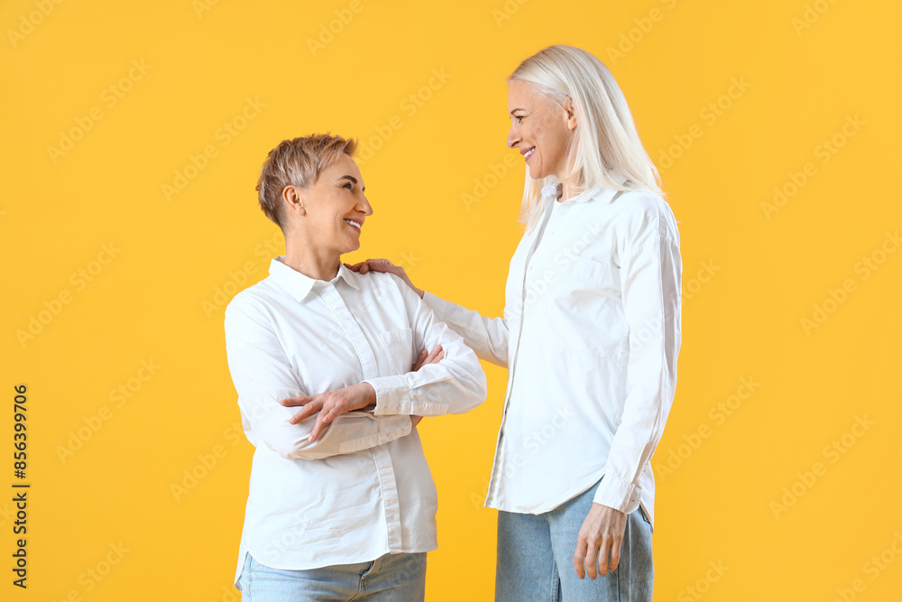 Beautiful mature women on yellow background
