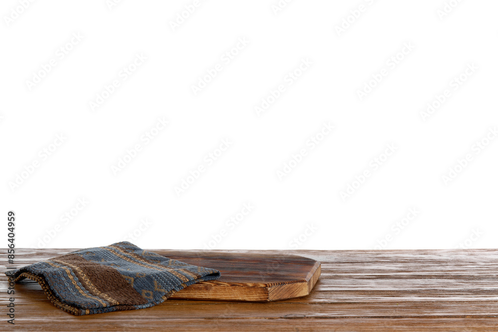 Cutting board with napkin on brown wooden kitchen table against white background