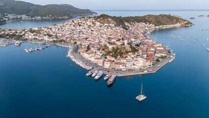 Wall Mural - Aerial panorama of the city and harbor of Poros island in the Saronic Gulf, Greece, during a colorful summer sunset