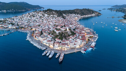 Wall Mural - Aerial panorama of the city and harbor of Poros island in the Saronic Gulf, Greece, during a colorful summer sunset