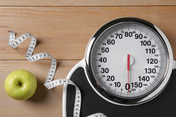 Canvas Print - Scale, measuring tape and fresh apple on wooden floor, flat lay