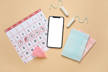 Wall Mural - Modern mobile phone, menstrual calendar and feminine hygiene products on color background