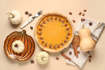 Wall Mural - Delicious pumpkin tart with almond, seeds and cinnamon on beige background