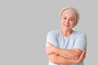 © Pixel-Shot - Mature woman after chemotherapy smiling on light background. Stomach cancer concept