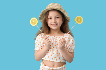 Wall Mural - Cute little girl with lemon slices on blue background