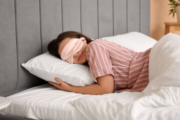 Canvas Print - Pretty young woman with mask sleeping in bed