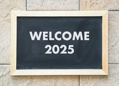 Welcome 2025, words on black chalkboard. New year concept.