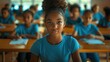 © evgenia_lo - A young girl with a blue shirt and a ponytail is sitting in a classroom with other students