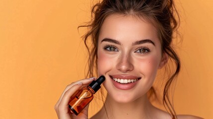 Wall Mural - A young woman with a radiant complexion, holding a bottle of serum