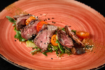 Wall Mural - Sliced Roast Beef with Tomatoes and Arugula on a Stylish Plate