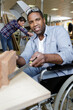 © auremar - disabled worker in wheelchair in a carpenter workshop