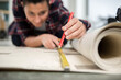© auremar - female repairman measuring carpet on floor