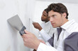 © auremar - man plastering wall with putty-knife close up image